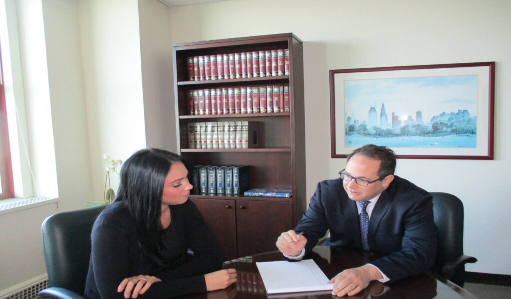 Rapaport Law Firm attorney Marc Rapaport meeting with a client in a New York City conference room